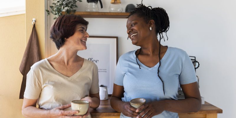 front-view-lesbian-couple-with-coffee-cups